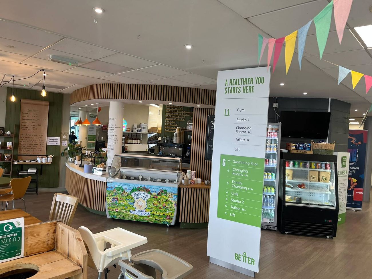 Feed Cafe counter with green panelling, timber slats and bunting